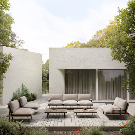 Nami 3 Seater Garden Sofa with beige cushions on an aluminium and iroko wood frame, shown on a wooden terrace with matching coffee tables and armchairs.