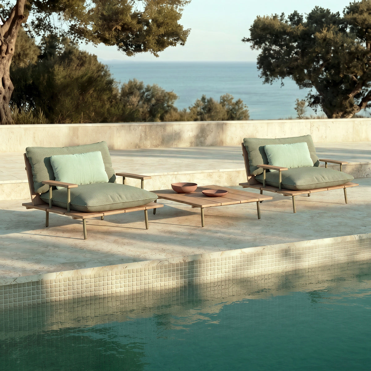 Nami Aluminium and Iroko garden armchairs with sage cushions and matching slatted coffee table on a poolside terrace overlooking the sea.