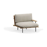 Nami garden armchair with iroko wood slatted frame and black metal legs, dressed with beige cushions and a wooden armrest, shown on a plain white background.
