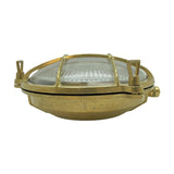 Small Cabin round bulkhead light in raw brass, with ribbed glass dome, brass cage grid, and thumb turn fixings, shown on a white background.