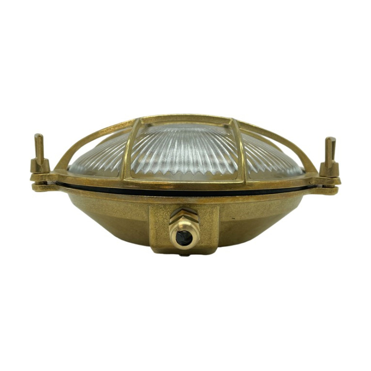 Grand Cabin round bulkhead light in raw brass with ribbed glass dome, grid cage cover, and three mounting lugs, shown on a plain white background.