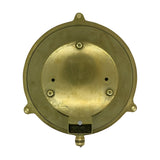 Rear view of the Grand Cabin round bulkhead light in raw brass, showing the solid brass back plate with mounting screws, cable gland, and three fixing lugs on a plain white background.
