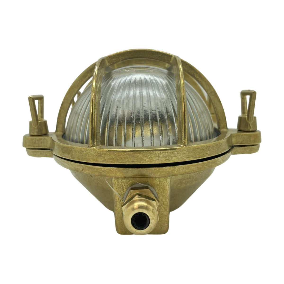 Horatio Oval Bulkhead Light in raw brass, with ribbed glass diffuser behind a crossed brass cage and side mounting lugs, shown on a plain white background.