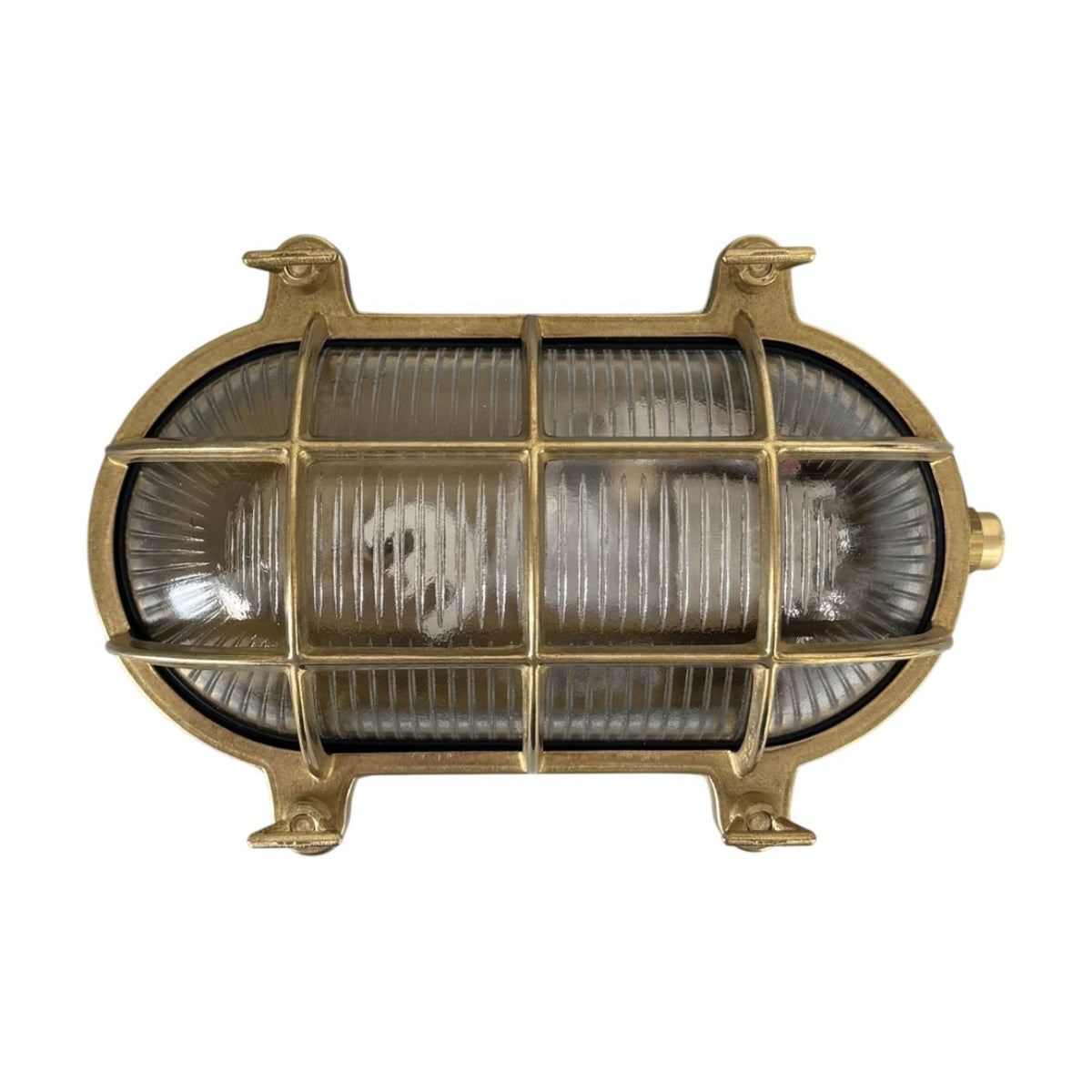 Horatio Oval Bulkhead Light in raw brass, IP64 rated, with ribbed glass diffuser behind a crossed brass cage and four mounting lugs, shown on a white background.