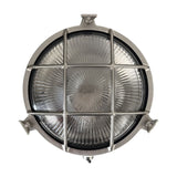 Small Cabin round bulkhead light in satin nickel brass, porthole style with cage grid over ribbed sunburst glass, IP64 rated, shown on a plain white background.