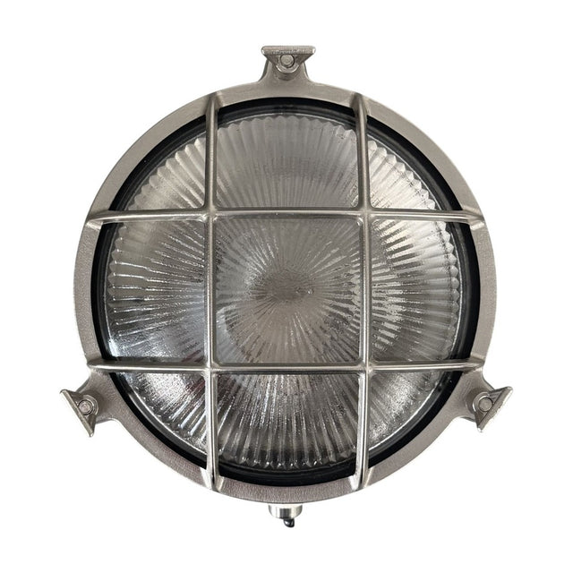 Small Cabin round bulkhead light in satin nickel brass, porthole style with cage grid over ribbed sunburst glass, IP64 rated, shown on a plain white background.