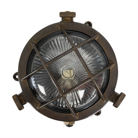 Mini Compass Guard round bulkhead light in antique brass, solid brass crossed-bar guard over domed ribbed glass with rim thumb screws, IP44, on a white background.