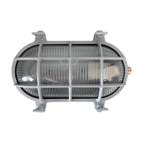 Horatio Oval Bulkhead Light IP64 in silver, showing a brass oval wall light with ribbed glass behind a protective cage and four corner mounting lugs, on a plain white background.