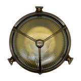 Trident Round Bulkhead Light in antique brass, featuring a three-arm cage guard over ribbed glass and three mounting brackets, shown against a plain white background.