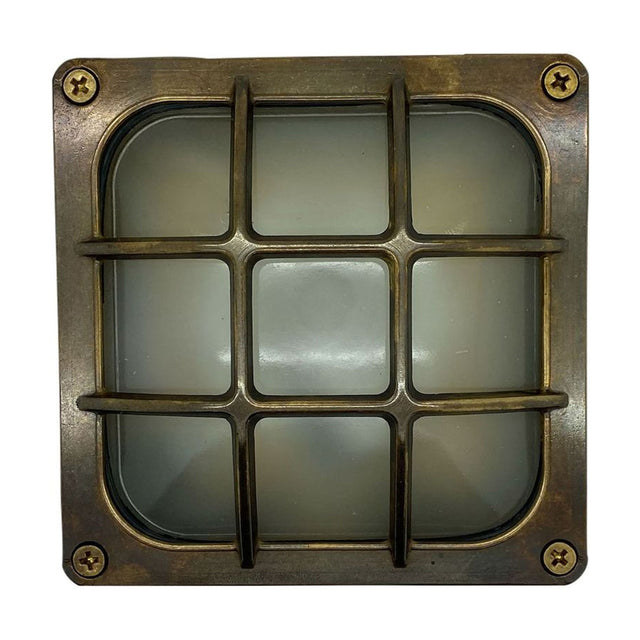 Francis Outdoor Wall Light IP64 in antique brass, square bulkhead design with frosted glass diffuser behind a fixed 3x3 bar guard, corner screws visible, shown on a plain white background.