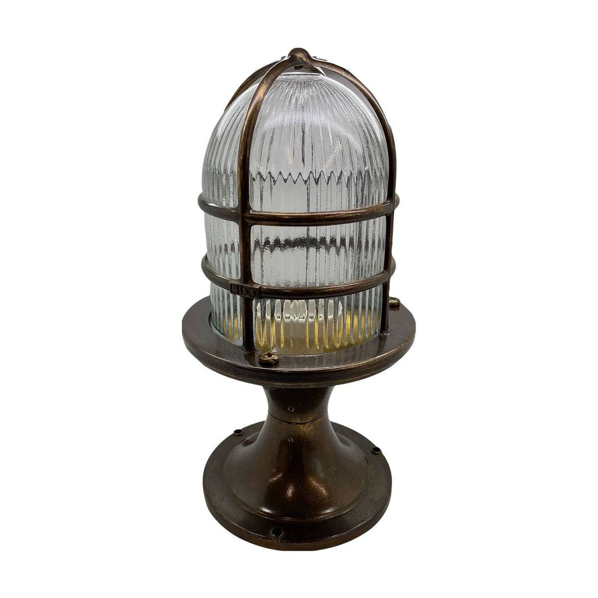 Wellington Grand Outdoor Post Light in antique brass, with a ribbed glass dome encased in a brass bar cage atop a flared pedestal base, shown on a plain white background.