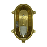 Interior view of the Small Siren oval bulkhead light in raw brass, showing the E27 ceramic lamp holder, mounting screws and cable gland, on a white background.