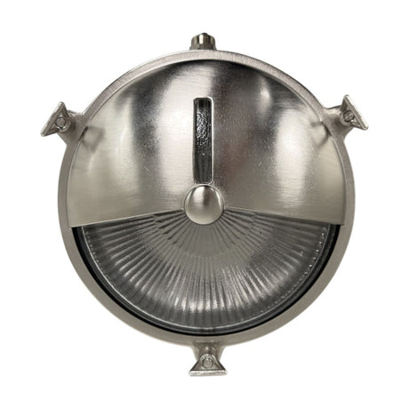 Trident Shield Round Bulkhead Light in satin nickel, a porthole-style outdoor wall light with brass body, half-moon shield, ribbed glass, and three fixing lugs on a plain background.
