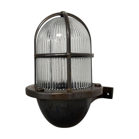 Armada Uplight Outdoor Wall Lantern in antique brass, with a ribbed glass dome and brass cage guard on a short wall bracket, IP64 rated, shown on a plain white background.