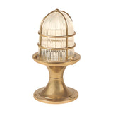 Wellington Grand IP54 outdoor post light in raw brass, with a brass cage over a ribbed glass dome on a flared pedestal base, shown on a plain white background.