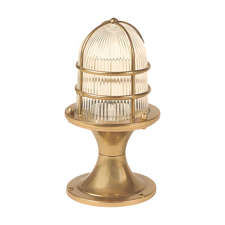 Wellington Grand IP54 outdoor post light in raw brass, with a brass cage over a ribbed glass dome on a flared pedestal base, shown on a plain white background.