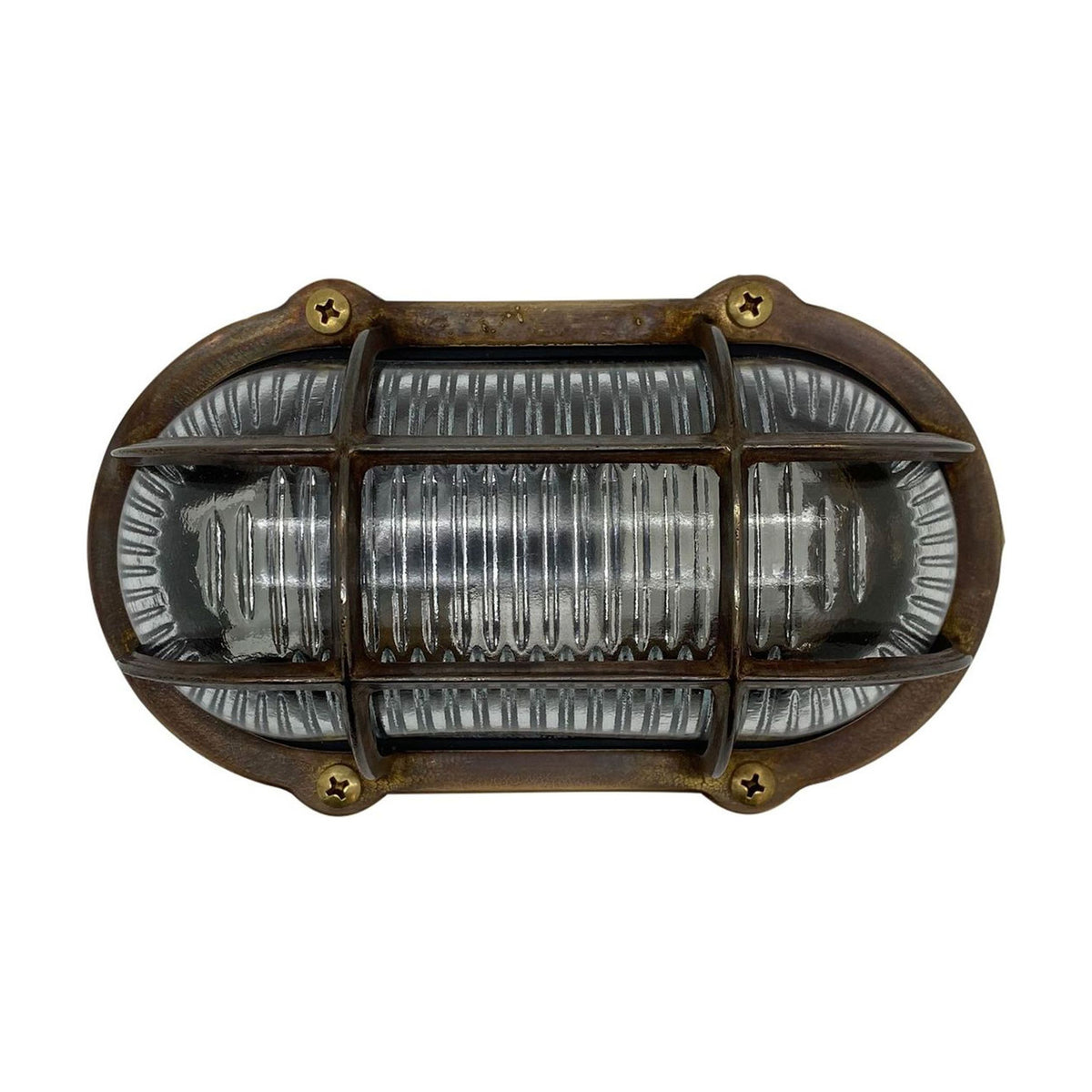 Merchant Oval Bulkhead Light in antique brass, with cross-head screws securing a protective cage over ribbed glass, IP64 rated, shown on a plain white background.