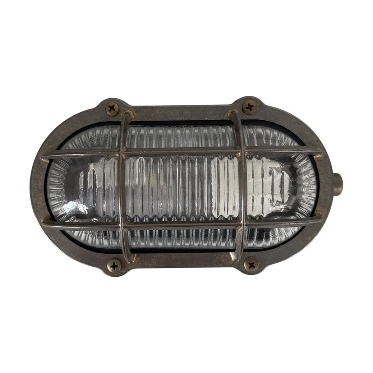 Merchant Oval Bulkhead Light in antique brass with ribbed glass and protective cage, secured by four corner screws, IP64 rated, shown on a plain white background.