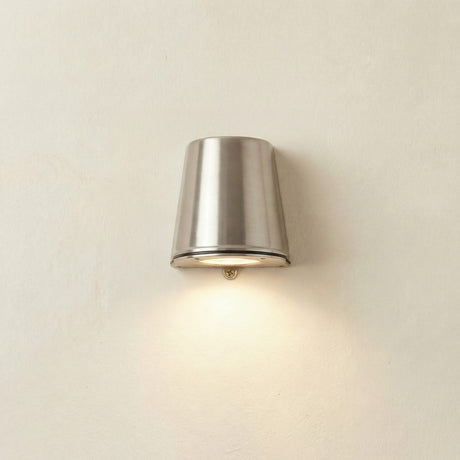 Mast Outdoor Wall Light IP65 in satin nickel, a tapered brass cylinder on a light wall, casting downward light through its base, IP65 rated.