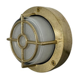 Walkway Guard round outdoor wall light in raw brass, with frosted glass lens, cross-bar brass guard, and screw-fixed flange, shown on a white background.