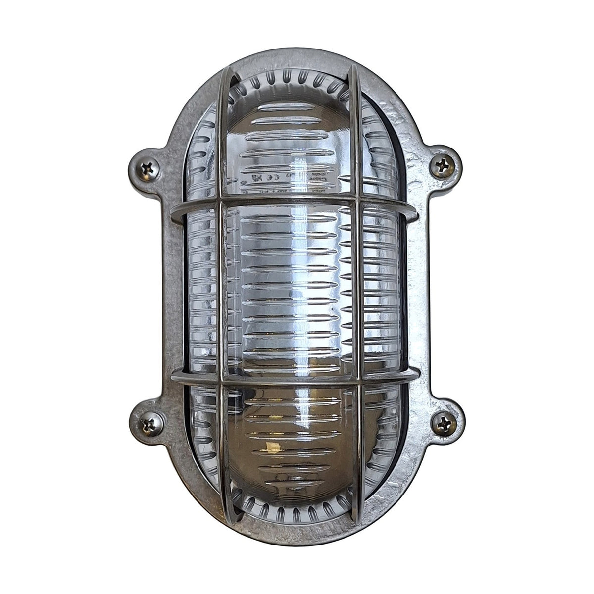 Merchant Flush Oval Bulkhead Light in satin nickel, with ribbed glass and a barred cage over the bulb, four-screw oval mount, shown on a plain white background.
