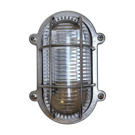 Merchant Flush Oval Bulkhead Light in satin nickel, with ribbed glass and a barred cage over the bulb, four-screw oval mount, shown on a plain white background.