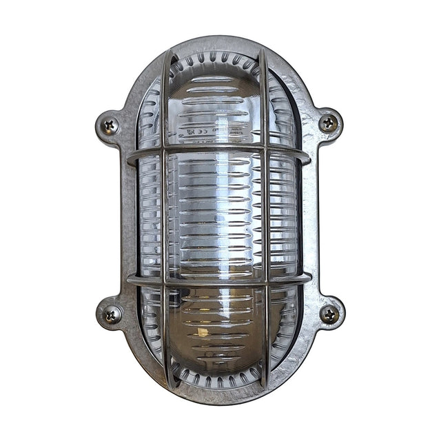 Merchant Flush Oval Bulkhead Light in satin nickel, with ribbed glass and a barred cage over the bulb, four-screw oval mount, shown on a plain white background.