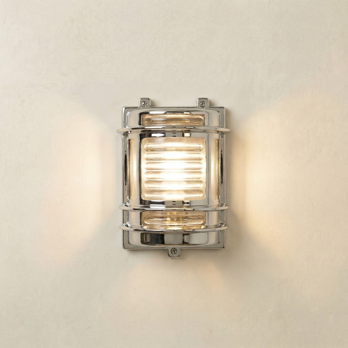 Cargo Outdoor Wall Light IP64 in mirror nickel, a brass bulkhead-style fixture with ribbed glass lens and metal guard bands, lit against a plain light background.