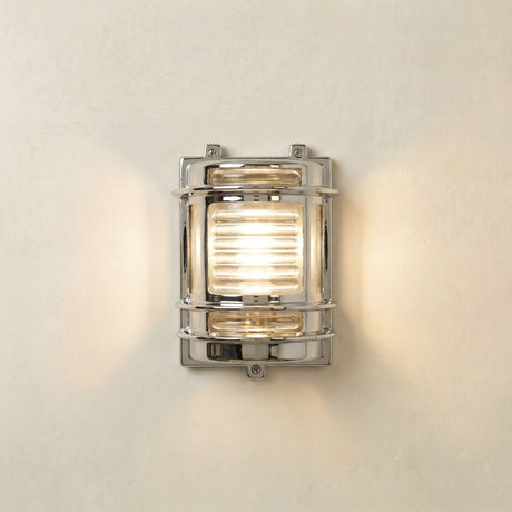 Cargo Outdoor Wall Light IP64 in mirror nickel, a brass bulkhead-style fixture with ribbed glass lens and metal guard bands, lit against a plain light background.