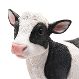 Close-up of the Standing Black Patch Cow Resin Figurine, 30cm, showing its textured white coat, black patches, pink nose and ears, and glossy dark eyes against a plain white background.