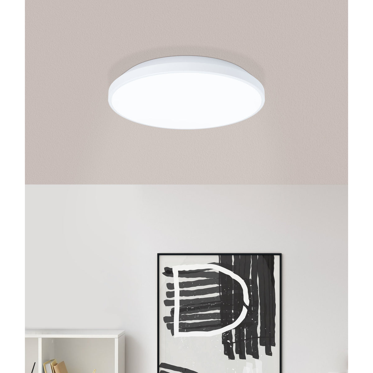 Nelbenne LED Downlight 24cm in white, round flush ceiling fixture with stepped rim, shown on a pale ceiling above a modern room with artwork and white furniture.