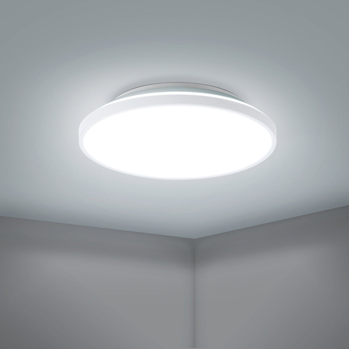 Nelbenne LED Downlight 31.5cm in white, a round flush ceiling light with flat diffuser, shown illuminated on a ceiling in a plain room corner setting.
