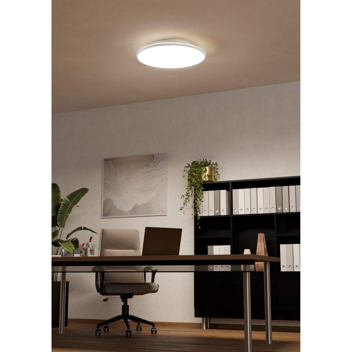 Round white LED downlight, Nelbenne 50cm, fitted flush to the ceiling of a home office with desk, chair and bookshelves below.