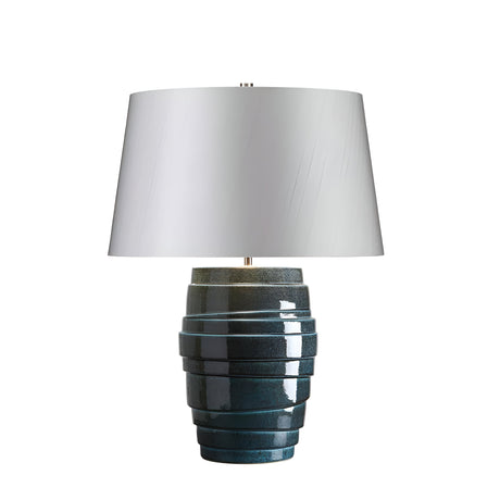 Introducing the Neptune 1 Light Table Lamp - Blue Glaze, a modern masterpiece featuring a glossy dark blue ceramic base with horizontal ridges. This stunning design is complemented by polished nickel accents and a wide white lampshade, all enhanced by an exquisite blue reactive glaze.