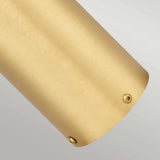 Close-up of the Newbrighton 1 Light Bollard in a brushed brass finish, showcasing small round screws or rivets on its metallic, cylindrical surface. The background is a light, neutral gray.