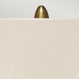 A brass, bullet-shaped finial peeks over the top edge of a Pearl Satin Shade, set against a neutral background. The Newham 1 Light Large Table Lamp - Bronze Ceramic/Pearl Shade showcases a cream-colored shade with a subtle textured pattern that elegantly complements its bronze ceramic base.