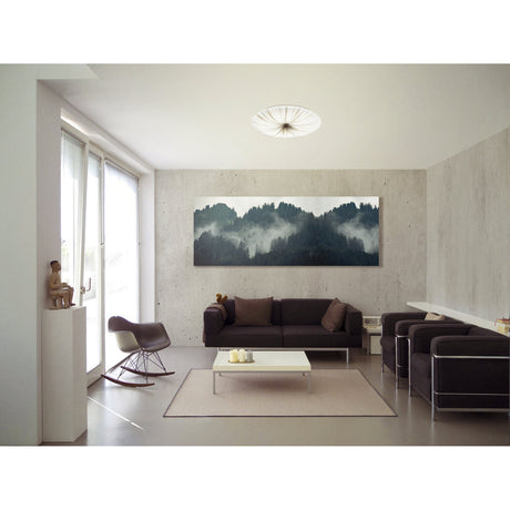 Nieves LED Flush Ceiling Light 51cm in white, round pleated-effect diffuser with fine silver stripes, shown mounted on a living room ceiling above a dark sofa seating area.