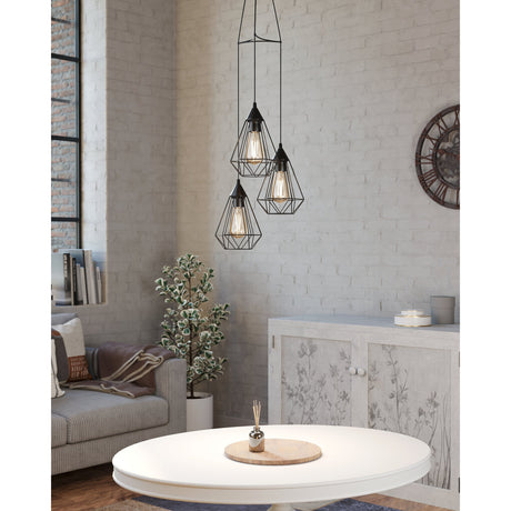 Nilbine 3 Light Pendant in black steel, three diamond-shaped wire cage shades at staggered heights from one ceiling plate, shown above a dining table in a living room setting.