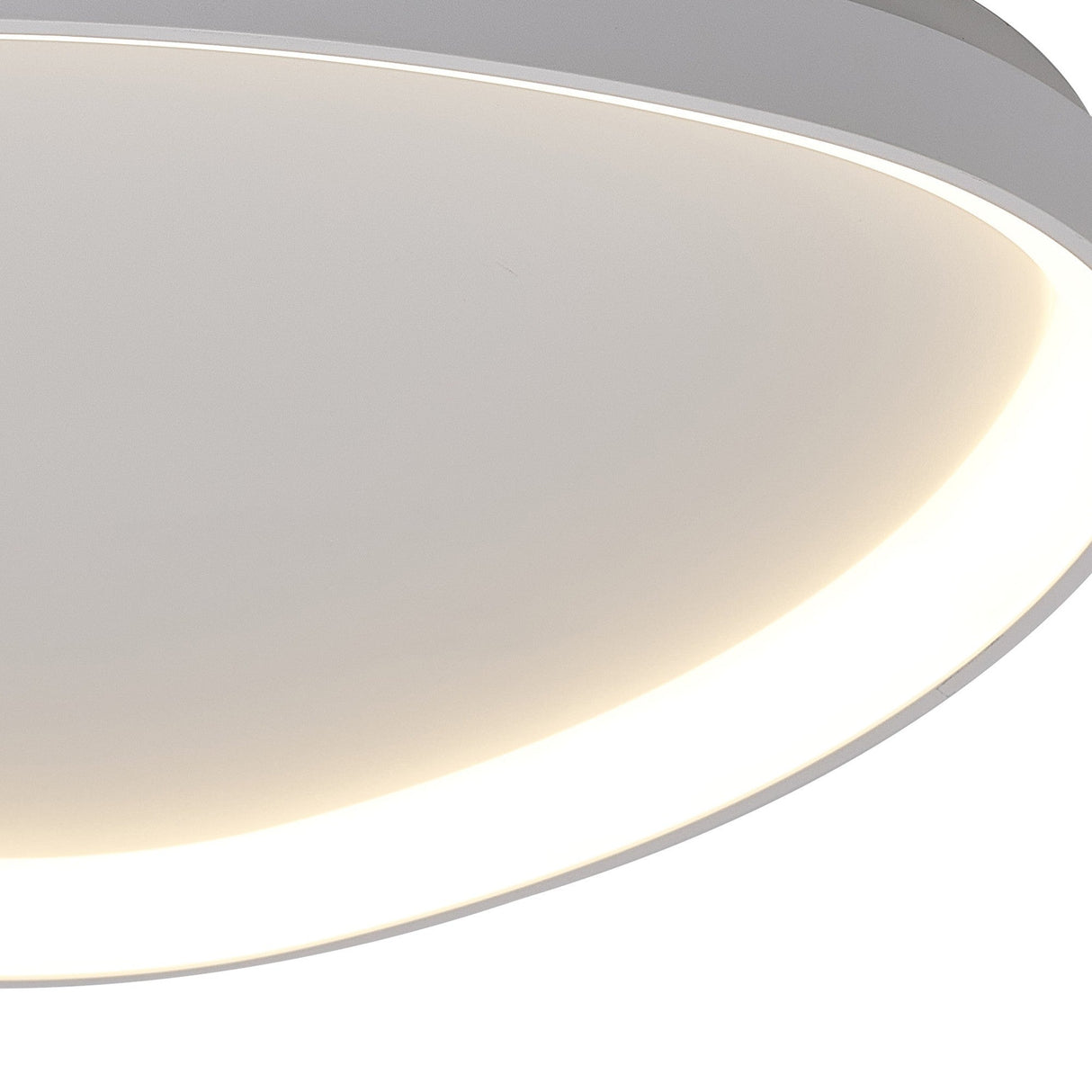 Close-up of the Mantra Niseko triangular flush ceiling light showing the white metal frame and continuous inner LED band emitting warm white light.