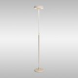 The Noa II Touch Dimmer LED Floor Lamp 15W 3000K in white features a slim, minimalist design with a round base and flat circular shade, offering soft adjustable light—all set against a plain, light grey background.