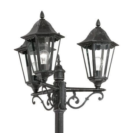 Nolmane 3 Light Lamp Post in black with silver patina, showing hexagonal glazed lanterns with pointed finials on scrolled aluminium arms against a white background.