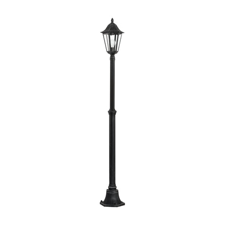 Nolmane Lamp Post in black with silver patina, a tall slim pole with six-sided glazed lantern head, canopy roof and finial, on a flared base, shown against a plain white background.