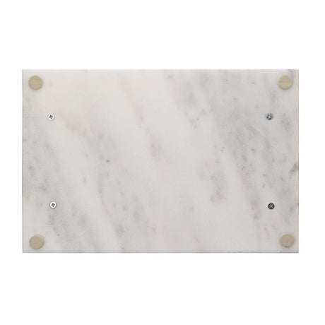 Rectangular white marble tray with soft grey veining, shown underside up with visible gold-coloured metal corner fittings and screws, on a plain white background.