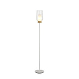 The Nora 1 Light Clear Glass Floor Lamp features a slim white stand, round base, and clear glass shade with a wooden accent. The glowing bulb adds Scandinavian style to any space. Shown on a plain white background.
