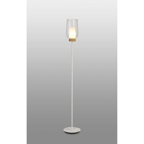 The Nora 1 Light Clear Glass Floor Lamp in white features a circular base, slender pole, wood-accented clear glass shade, and emits gentle Scandinavian light against a gray gradient backdrop.