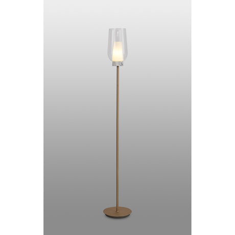 The Nora 1 Light Clear Glass Floor Lamp features a slim gold and white stand with a round base, topped by a clear glass shade that softly glows, adding elegant modern lighting to your space.