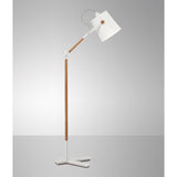 The Nordica 1 Light Floor Lamp in matt white with an ivory white shade features wooden accents and adds subtle Scandinavian style against a plain gray background.