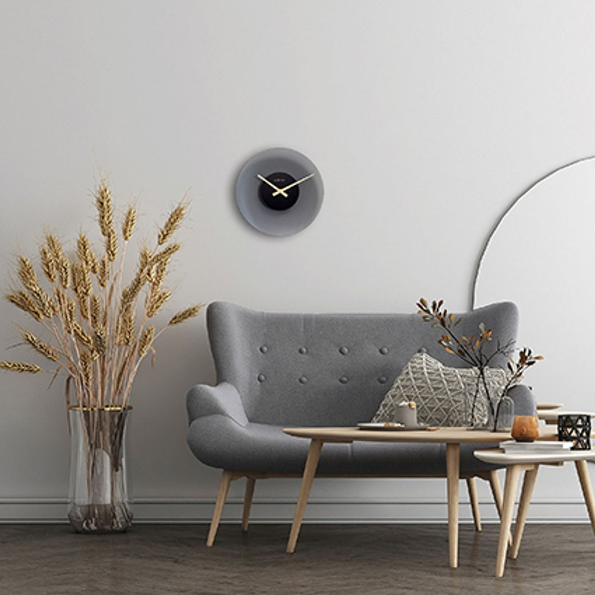 Float Round Silent Frosted Glass Wall Clock, 40cm, with black centre dial and gold hands, shown above a grey sofa in a living room setting.