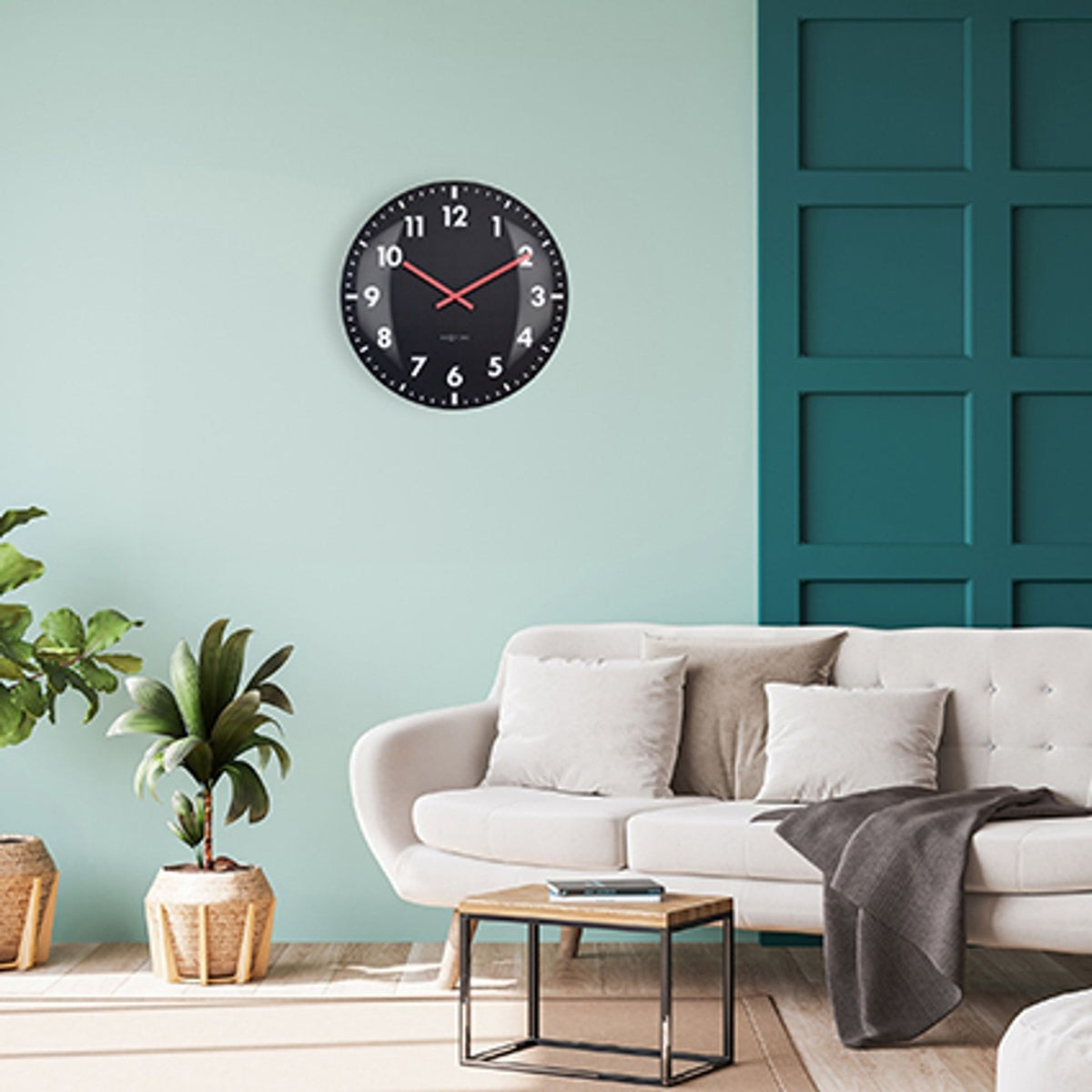 Duomo Domed Glass Wall Clock 50cm in black with white numerals and red hands, shown mounted on a mint green living room wall above a sofa.