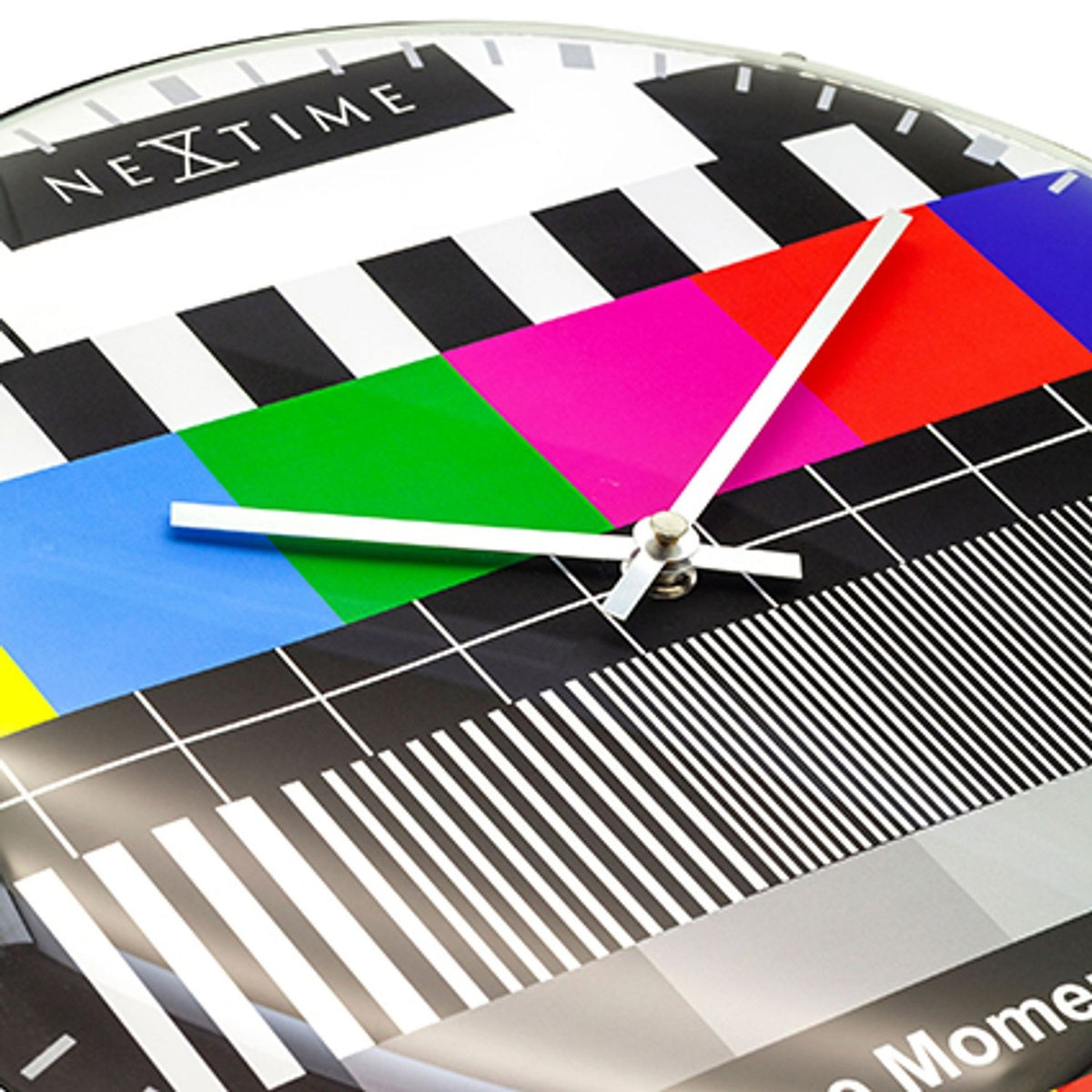 Close-up of the TV Testpage Round Dome Glass Wall Clock, 35cm, showing colour bars, black and white stripes, grid lines, slim silver hands and domed glass finish.